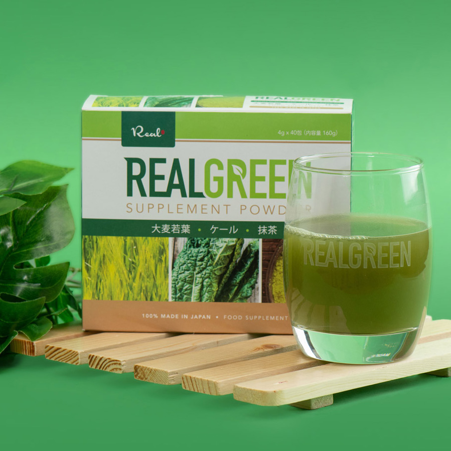 Real Green Tea, with glass containing the tea and the box behind the glass.
